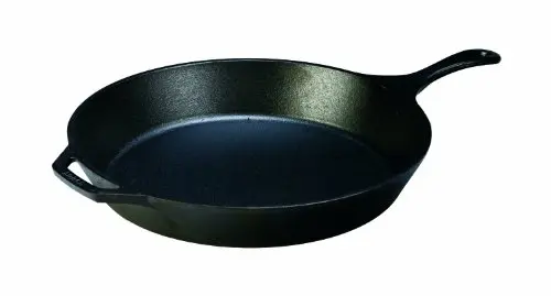 Lodge 15 inch cast iron skillet searing multiple steaks on stovetop