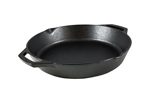 Lodge 12 inch cast iron skillet with dual handles on glass top stove