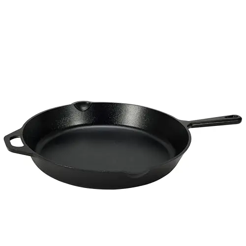 Amazon Basics 15 inch cast iron skillet with multiple steaks cooking