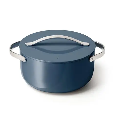 Caraway ceramic nonstick Dutch oven in navy blue on induction stove