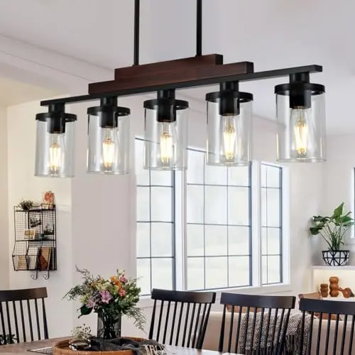 TWIG 5-light matte black pendant light with wood and clear glass shades over a kitchen island